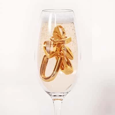Jewelries Sparkle Inside Champagne Glass in fake-out-of-home ad of Hey Harper